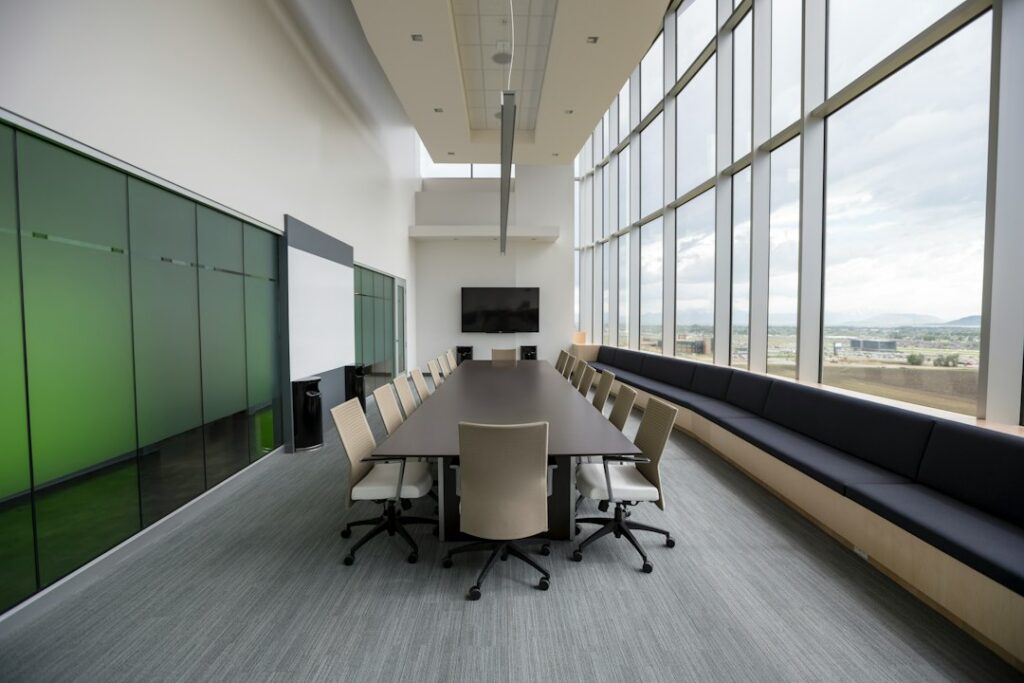 Long timber boardroom table with chairs, the kind of meeting room an epoxy resin conference table is designed for