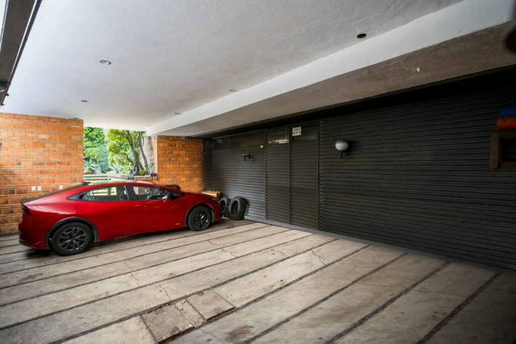 Car parked on a clean concrete floor, the kind of space an epoxy garage floor coating protects