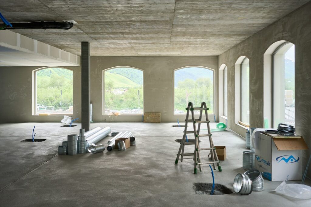 Bare concrete floor in an empty room ready for testing and preparation before a concrete epoxy coating