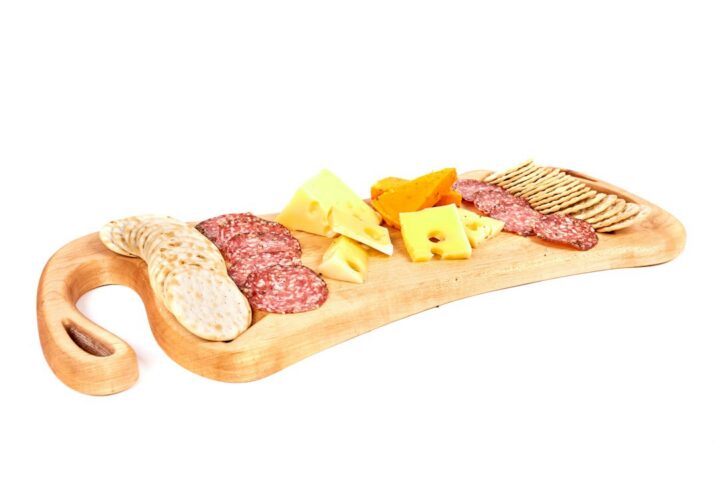 Wooden serving board with cheese and crackers, the kind of piece people finish with food safe epoxy