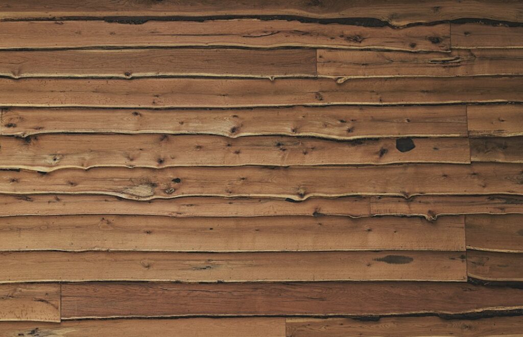 Close-up of a sawn wooden board showing grain and growth rings, the kind of detail to inspect when choosing live edge slabs