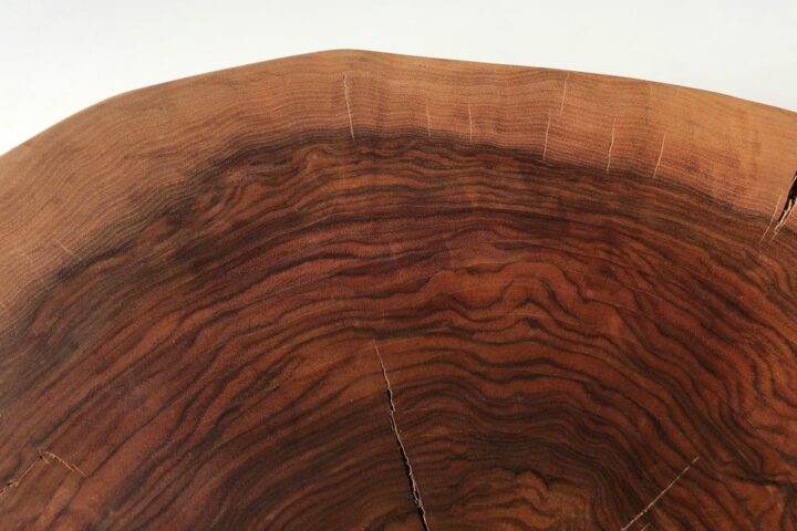 Natural wooden slab showing grain and edge character, the kind of live edge wood used for bespoke furniture