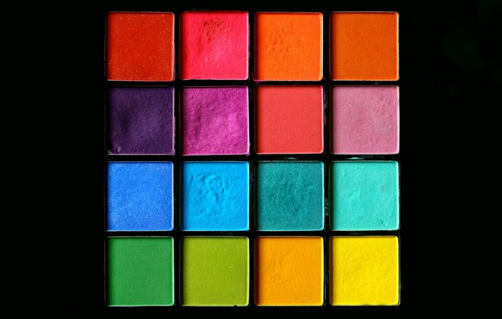 Rainbow of shimmering pressed pigments showing the range of mica powder colours used to tint resin