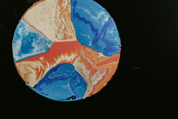 Blue and orange fluid pour artwork of the kind beginners create with a resin art kit