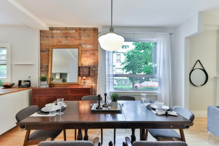 Solid wood dining table with chairs in a dining room, the setting for a resin dining table in a UK home