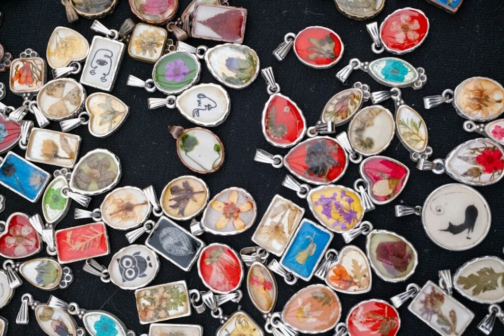Close-up of small clear handmade pendants, the kind of jewellery often made with UV resin