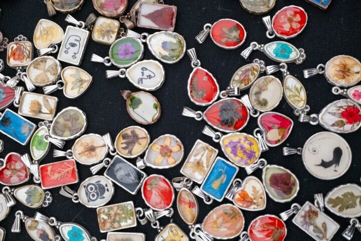 Close-up of small clear handmade pendants, the kind of jewellery often made with UV resin
