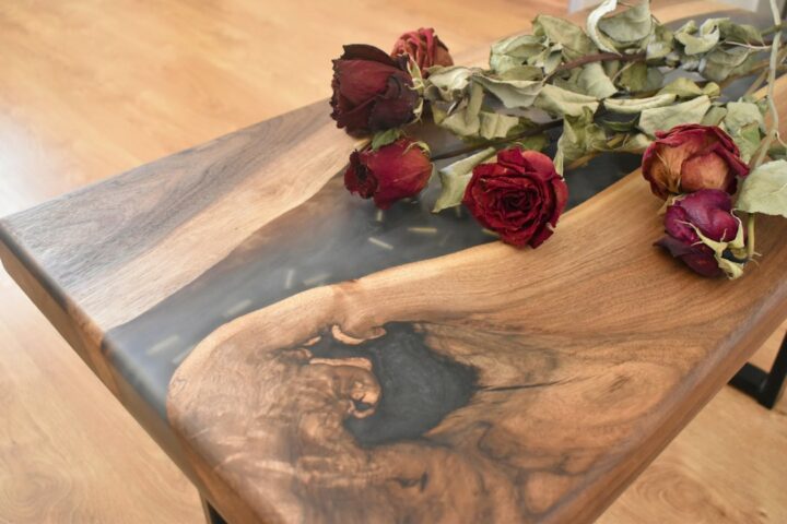 Wooden table with flowers set in clear resin, where ultra clear epoxy keeps the inlay visible