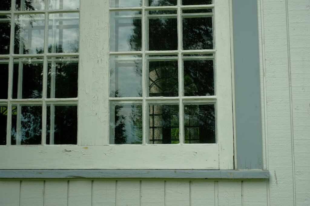 Rotten window sill corner being rebuilt with wood rot repair epoxy filler