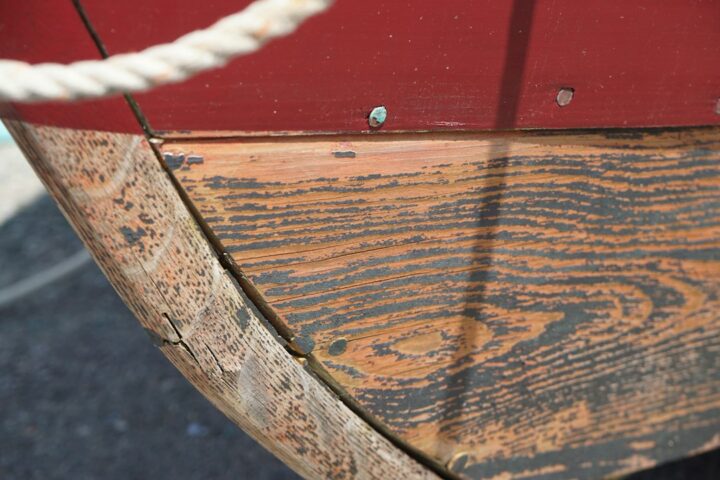 Marine epoxy being rolled onto a plywood boat hull during construction
