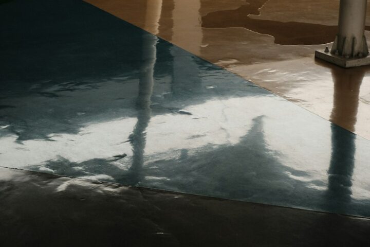 Glossy epoxy wood floor coating on a plywood workshop floor