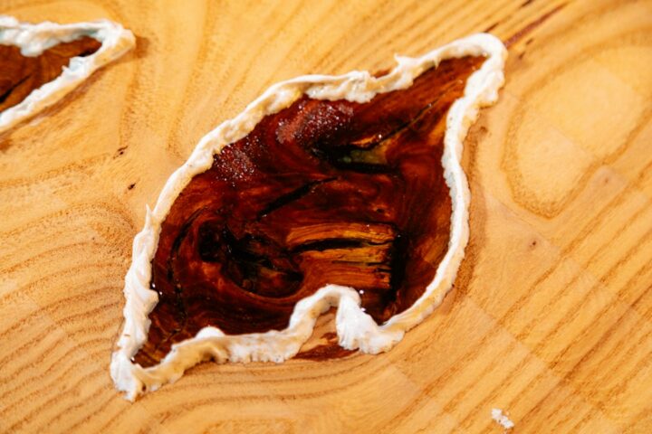 Freshly poured clear epoxy curing on a timber surface, showing how long epoxy takes to dry