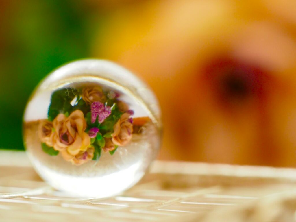 Clear resin casting of a paperweight with dried flowers embedded inside